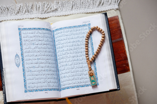 Wallpaper Mural The holy Quran and prayer beads or tasbih on a rehal, capturing a serene atmosphere of devotion Torontodigital.ca