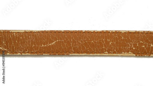 Close up of a brown synthetic leather belt that is damaged and peeling isolated on a white background. Grunge pattern and texture of the belt. Copy space for text. For graphic design, 3D rendering 