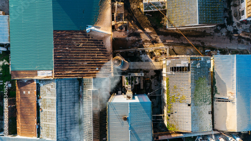 Aerial view of a collage of rooftops, displaying diverse textures and tones, from corrugated metal to aged tiles, creating a captivating mosaic, Sremska Mitrovica, Vojvodina, Serbia.