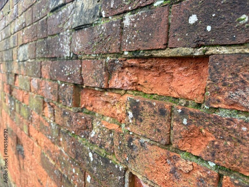 Fotografie Old weathered brick wall in state of disrepair