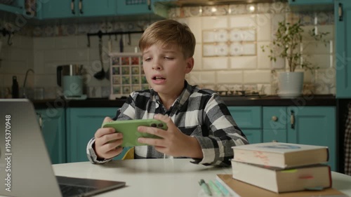 Boy Playing Mobile Games and Reacting Emotionally