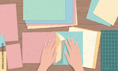 Hands Arranging Colorful Handmade Paper Sheets on a Wooden Table