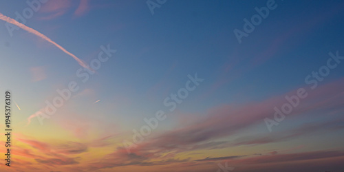 Swirling orange and purple sunset clouds in a vibrant sky