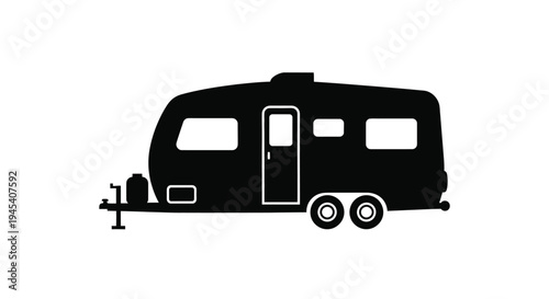 Black silhouette of a classic travel trailer against a white background silhouette