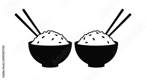 Two black bowls of rice with chopsticks stark silhouette