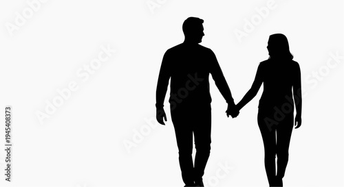 Silhouette of a romantic young couple walking together while holding hands during a sunny afternoon