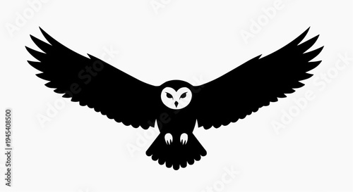 A silhouette of a majestic barn owl in flight with its wings spread wide to show its unique shape