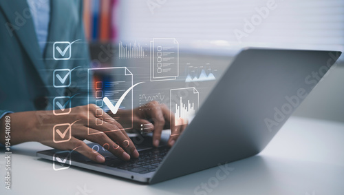 Obraz na plátně Business professional typing on laptop managing digital checklist and document w