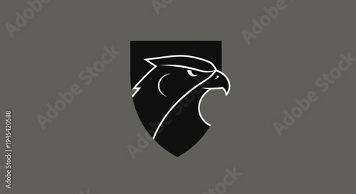 Minimalist black eagle head in shield emblem illustration. Modern graphic design featuring a powerful bird profile symbol.