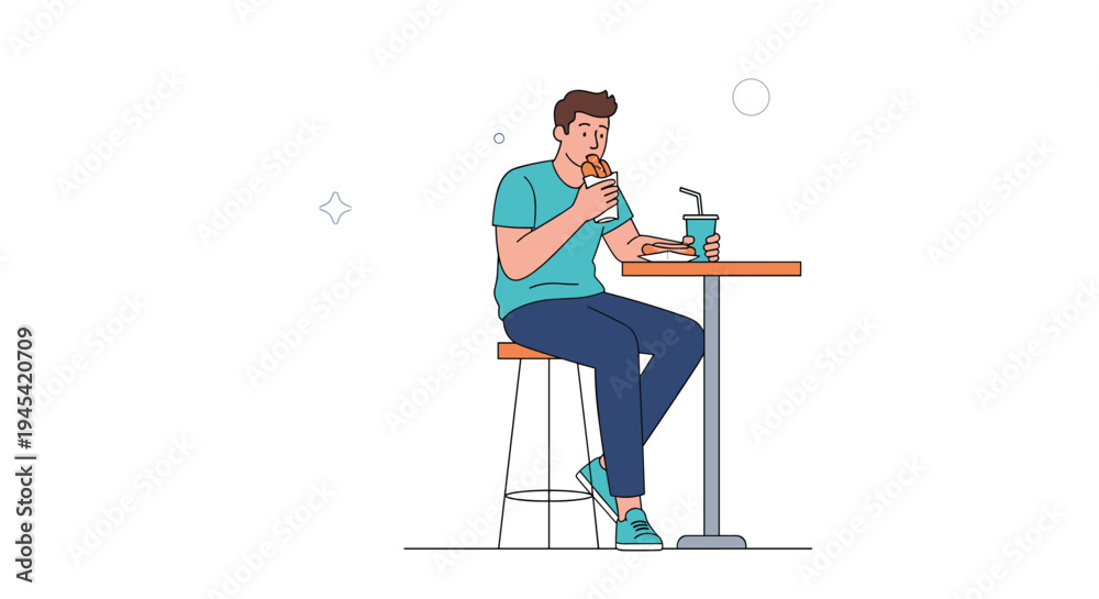 Fototapeta premium Casual man sitting at a bar table is eating a large hot dog and drinking a soda while taking a break in a cafe.