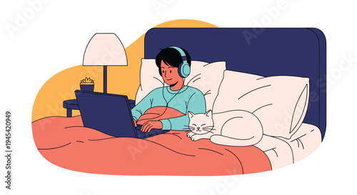 Young person relaxes in bed while wearing headphones and using a laptop computer next to a sleeping white cat at night.