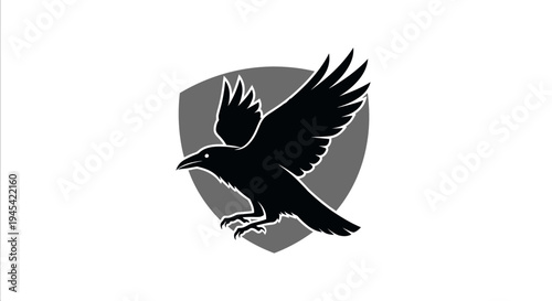 Dynamic black crow or raven in flight emblem over a gray shield background, stylized vector graphic design