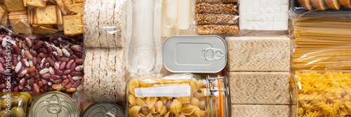 Essential home food stock for military operations and crises and for the period of quarantine and isolation, canned food, pasta, flour and nonperishable items,the concept of stay at home, banner