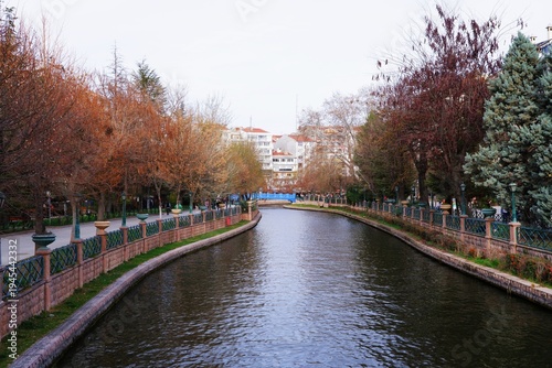 Canal flowing through a city park in autumn