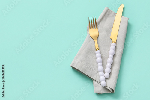 Golden cutlery with napkin ...