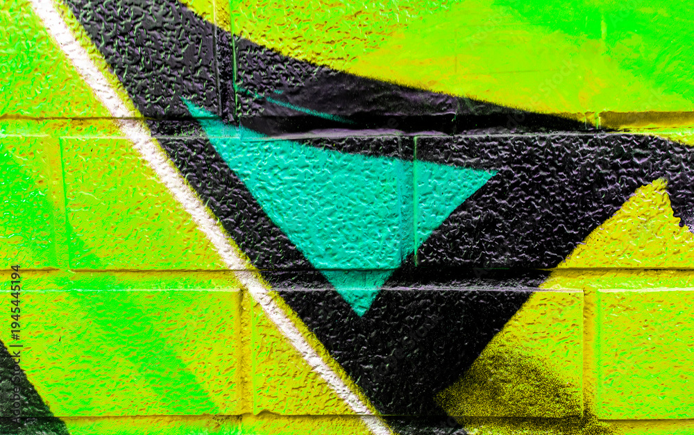 Fototapeta premium Art under ground. Beautiful street art graffiti background. The brick wall is decorated with abstract drawings house paint. Modern style urban culture of street youth. Abstract picture on wall