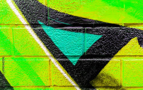 Art under ground. Beautiful street art graffiti background. The brick wall is decorated with abstract drawings house paint. Modern style urban culture of street youth. Abstract picture on wall