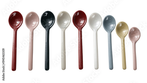 A colorful array of ceramic spoons in various sizes, showcasing a harmonious blend of pastel shades and vibrant colors on a transparent background.