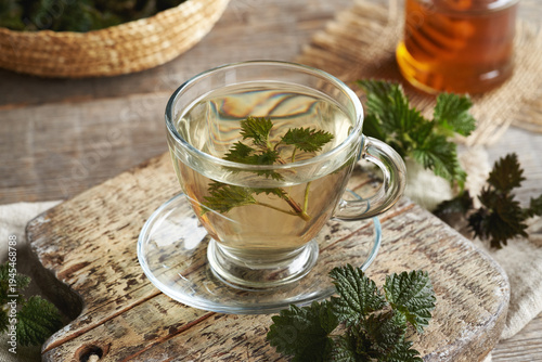 Nettle tea in a glass cup in spring. Herbal medicine.