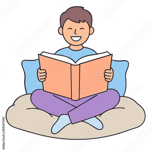 A young boy sitting on a beanbag chair reading a large book with a happy expression
