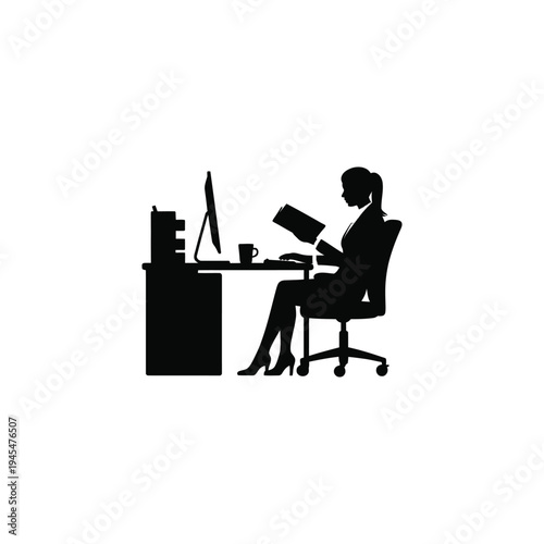 A woman sitting at a desk working on her computer