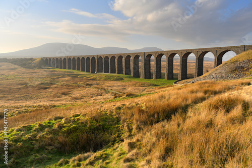 A glorious morning in the British countryside with spring sunlight at The Ribblehead Viaduct, Yorkshire Dales, UK.