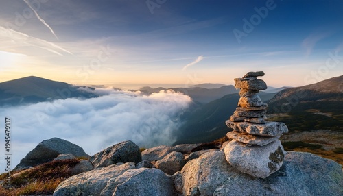 Serene Mountain Landscape With Stacked Stones On Rocky Foreground Soft Mist Enveloping Hills At Dawn