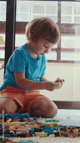 A little boy play with toys at home
