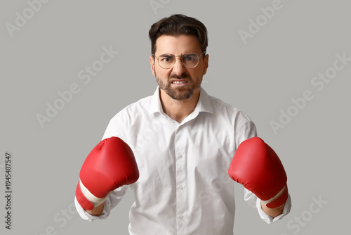 Angry businessman in boxing...