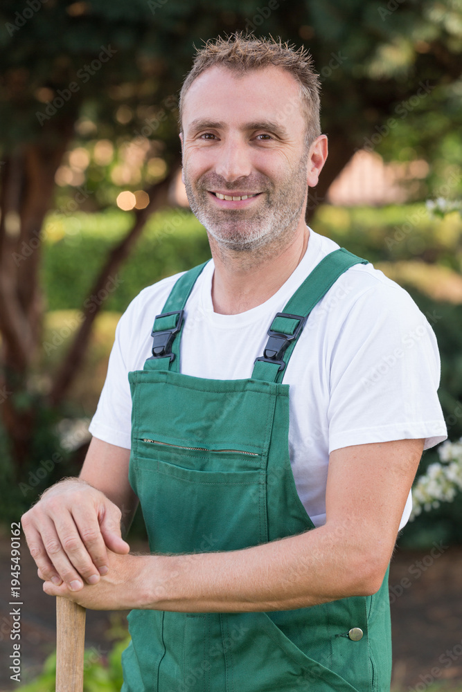 Fototapeta premium smiling man gardener standing outdoors