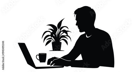 Silhouette of a man working on a laptop with a plant and coffee nearby