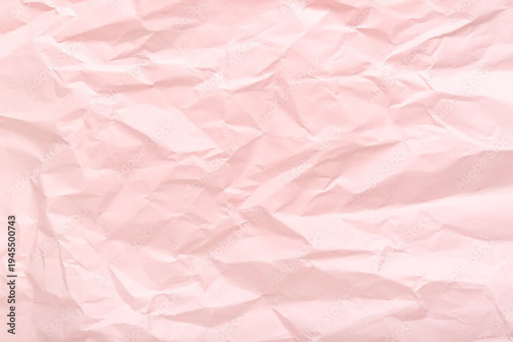 Fototapeta premium Pink crumpled sheet of paper as background, top view