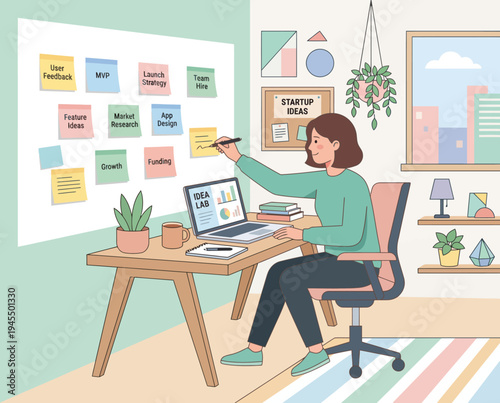 woman working on laptop at desk with sticky notes on wall.