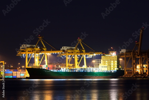 Stock images of Ship carrying containers with crude oil barrels from the harbour. Ship blocked in harbour.