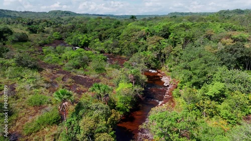 Wallpaper Mural Drone view over a river at sunrise in the Amazon rainforest, capturing golden morning light, calm water reflections, and dense tropical forest stretching into the distance. Torontodigital.ca