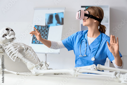 Female doctor using VR glas...