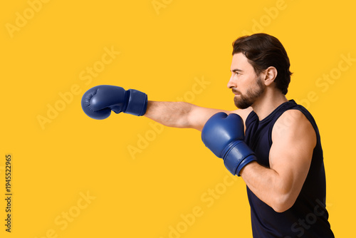 Young male boxer with boxin...
