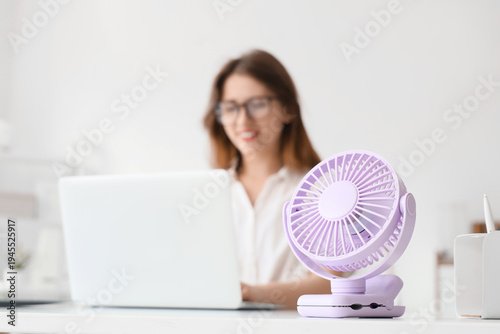 Small electric fan on table...