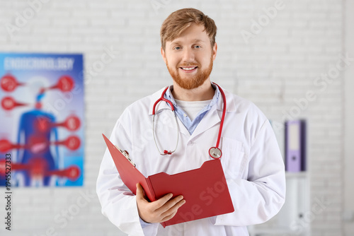 Young male doctor with fold...