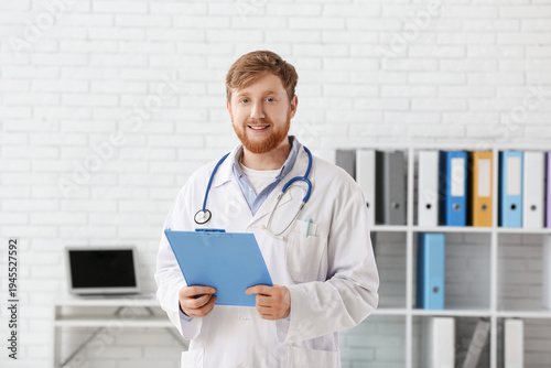 Young male doctor with clip...