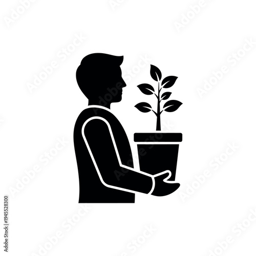 Man holding potted plant symbolizing growth and care.