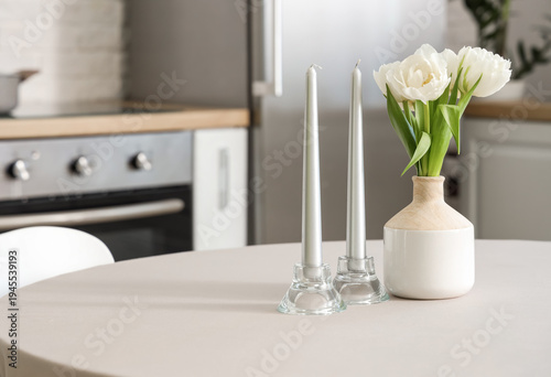 Silver candles and vase wit...
