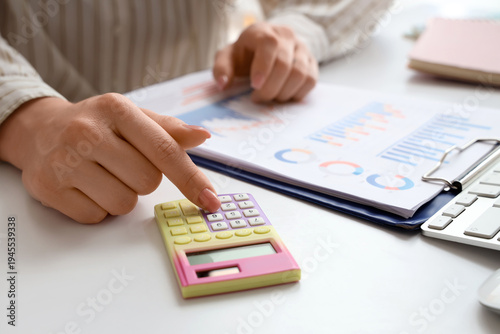 Female accountant with calc...