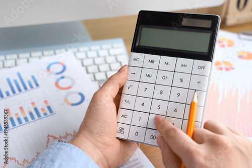 Female accountant with calc...