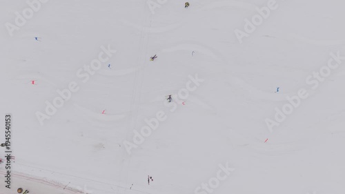 Aerial top view of parallel slalom ski race with two athletes racing down snowy slope