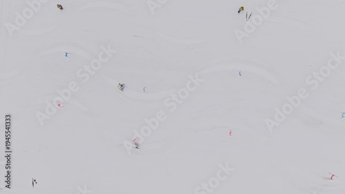 Aerial top view of parallel slalom ski race with two athletes racing down snowy slope