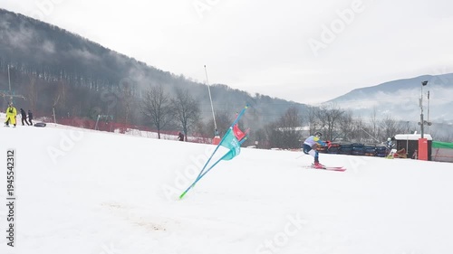Alpine skier hitting slalom gate during parallel slalom race in slow motion