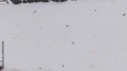 Aerial top view of parallel slalom ski race with two athletes racing down snowy slope