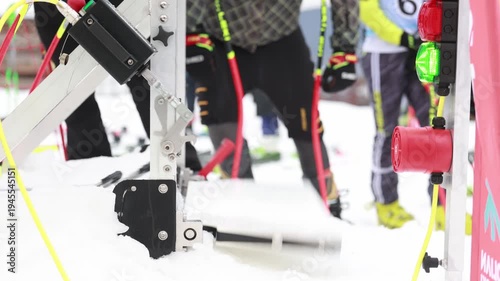 Ski race start gate opening as alpine skier launches from competition start