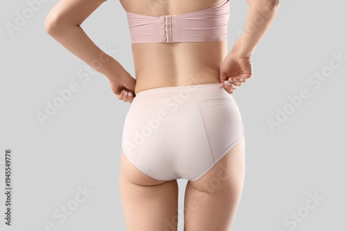 Young woman in beige menstr...